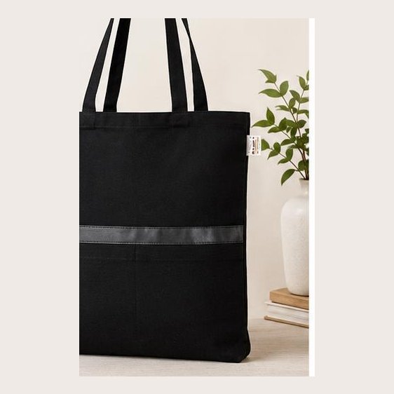 Black canvas tote with leatherite strip and dual pockets