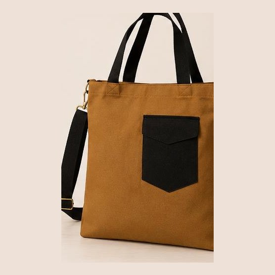 Tan canvas tote with black pocket and sling